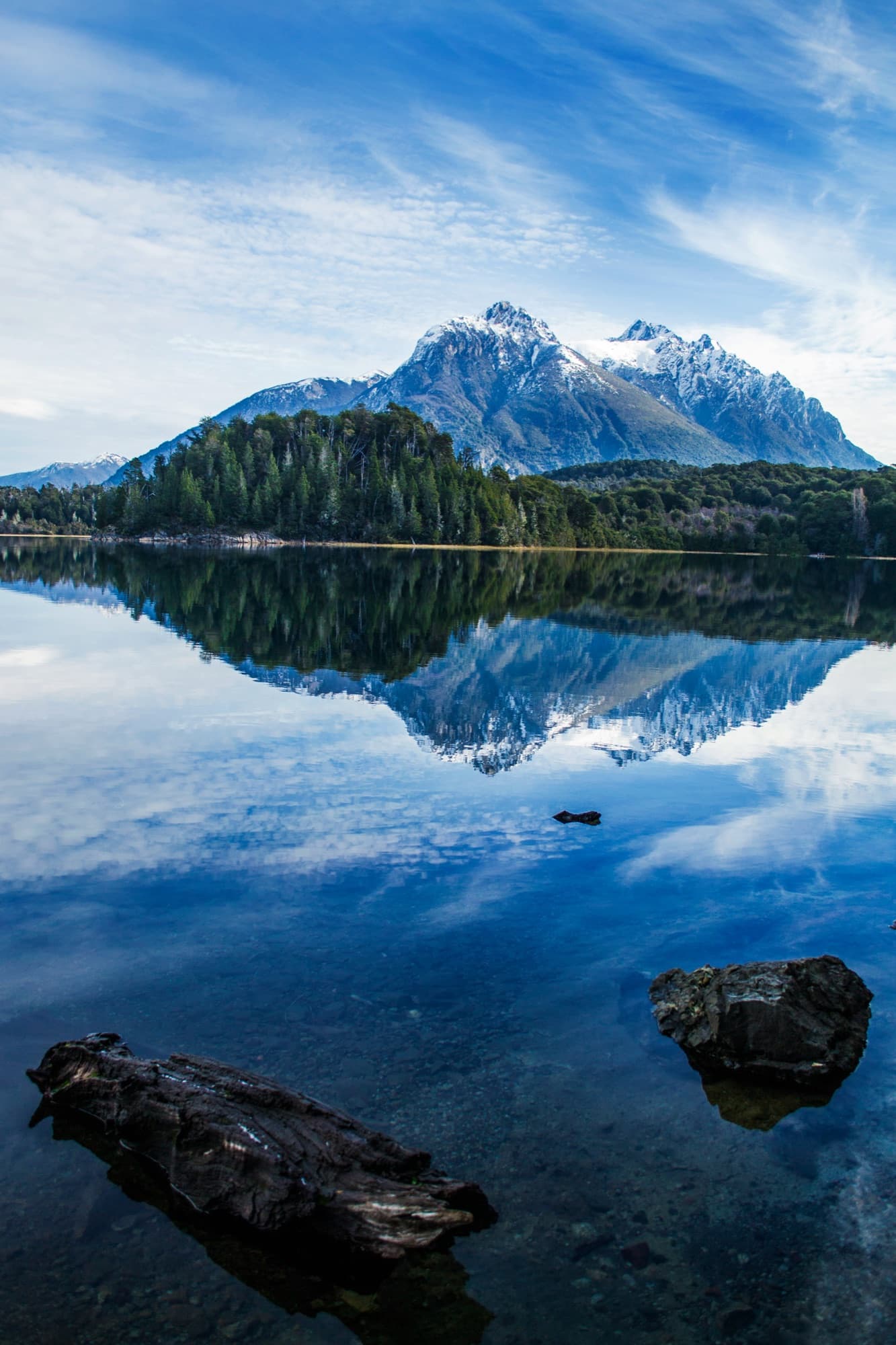 A snow-capped peak mirrored in still Patagonian water